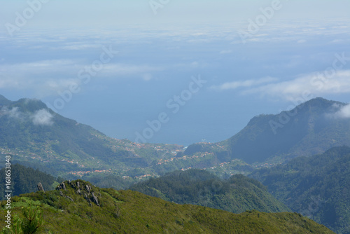 Panoramic view of maritime population from volcanic mountain above the clouds on the island of madeira