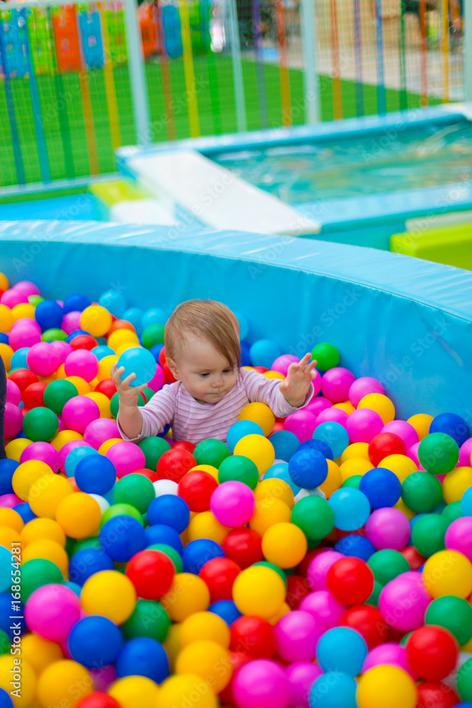 Newborn baby plays in the pool with balls Newborn baby plays in the pool with balls