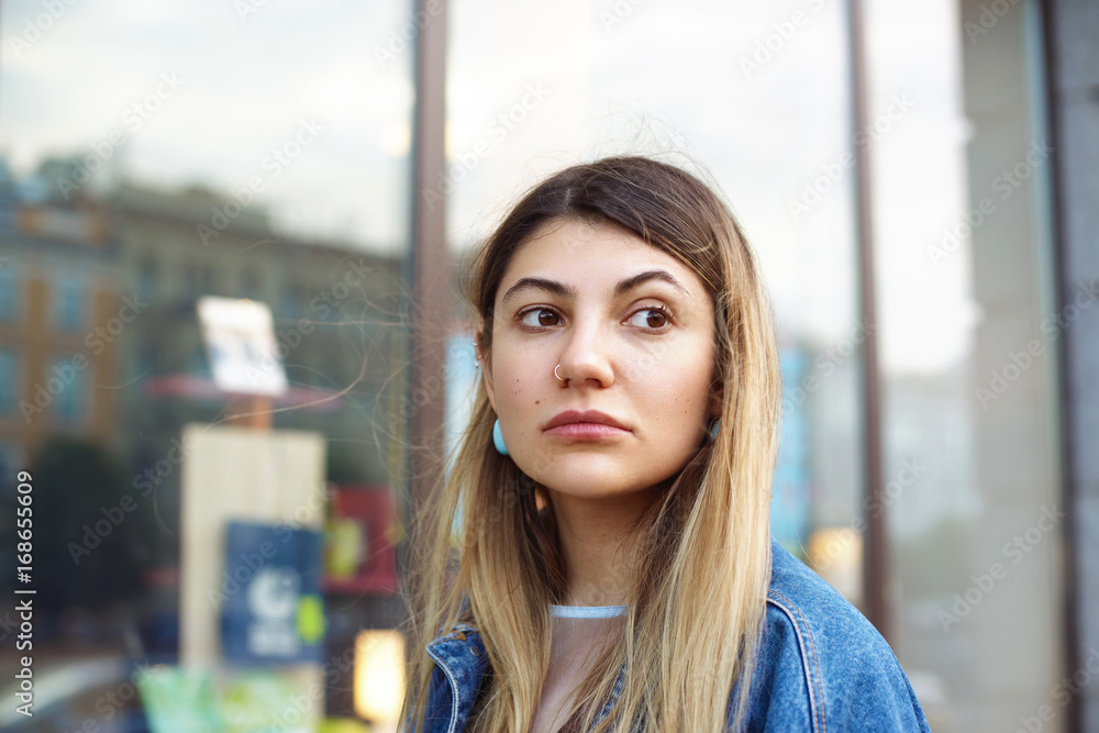 Hipster girl with blonde hair and nose-ring walking on streets of big city,  sightseeing, visiting local curiousities while spending summer vacations in  foreign country. People, travel and holidays Stock Photo | Adobe