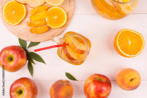 Ice tea with fresh fruit on a wooden background
