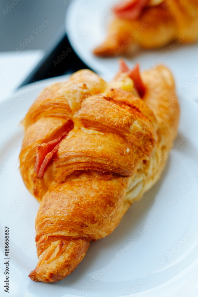 Fresh Croissants on the white plate. Selective focus