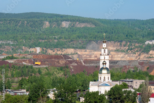 The view of Mednorudyanskoye opencast mine, Holy Trinity Church and the remains of mountain Vysokaya, Nizhny Tagil, Sverdlovsk region, Russian Federation