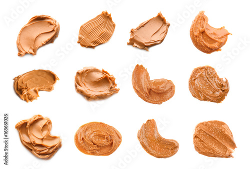 Collage of peanut butter on white background photo