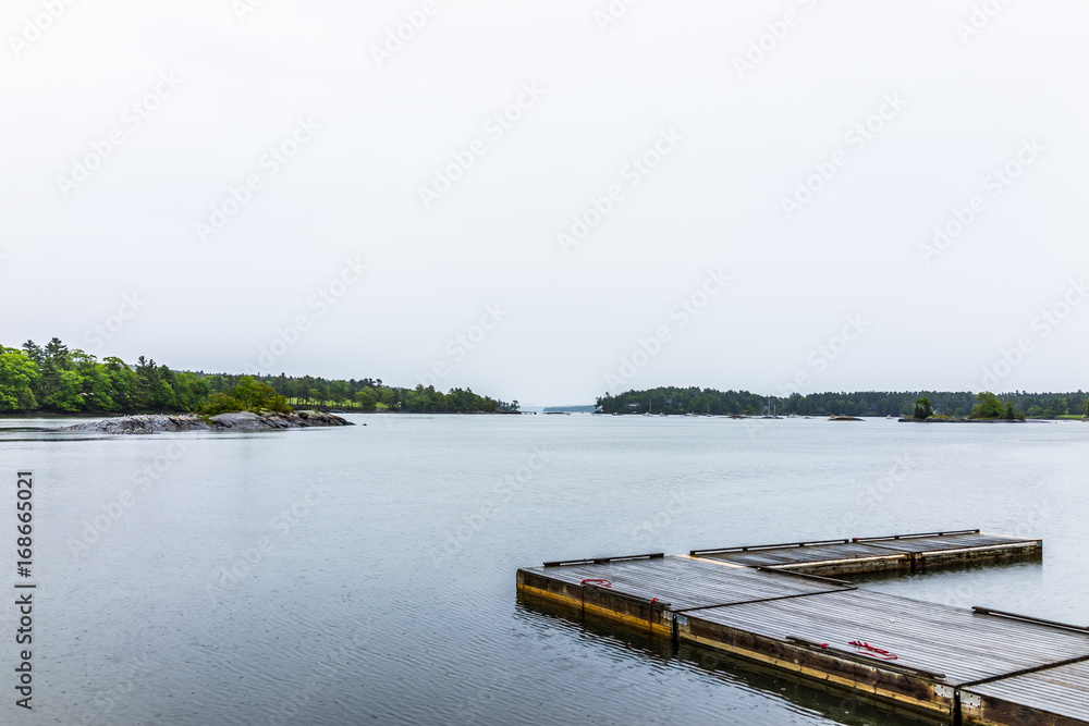 Blue Hill, Maine empty harbor during rainy, cloudy weather with wooden dock