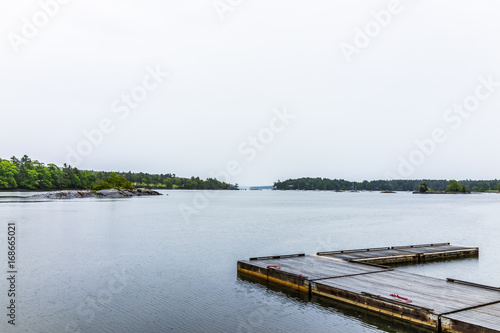 Blue Hill, Maine empty harbor during rainy, cloudy weather with wooden dock © Kristina Blokhin