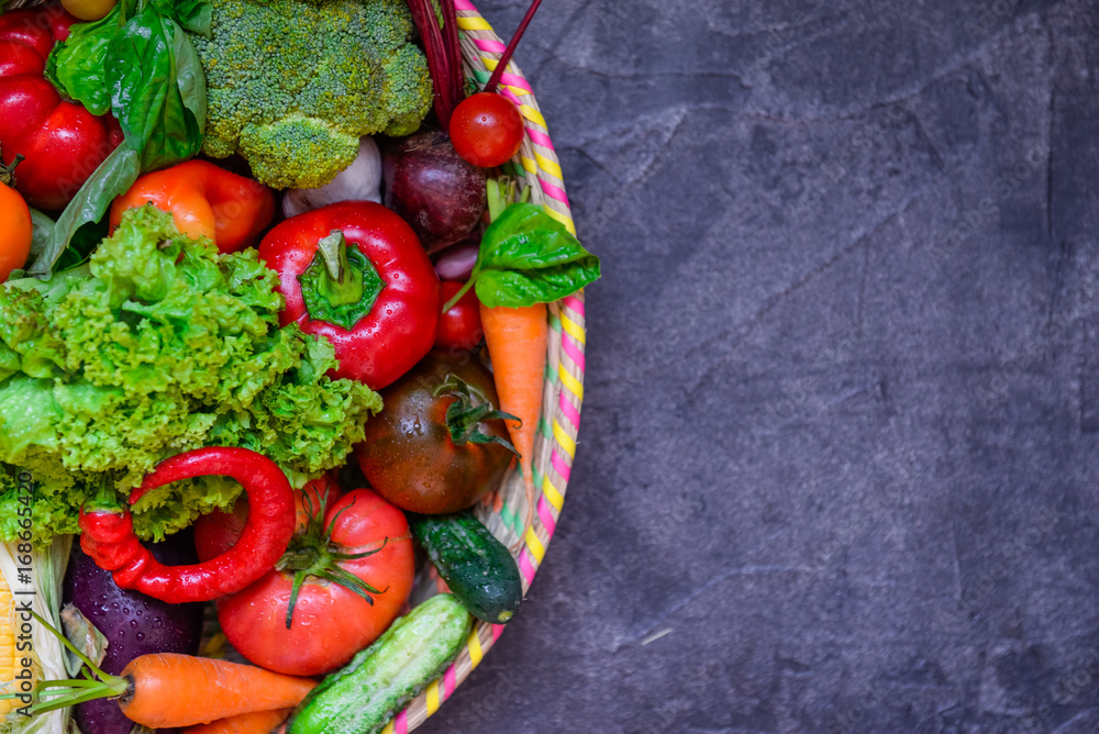 Top view Part of Big Basket with different Fresh Farm Vegetables on the dark concrete background. Harvest. Food or Healthy diet concept.Vegetarian.Copy space for Text, .selective focus. Top view Part of Big Basket with different Fresh Farm Vegetables on the dark concrete background. Harvest. Food or Healthy diet concept.Vegetarian.Copy space for Text, .selective focus.