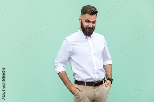 Canvas Print Cunning businessman, hid his hands in his pockets and looking slyly at camera