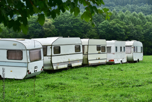 Parking with annuated camper trailers. Row of old-fashioned caravans on a campsite in the Belgian Ardennes. © defotoberg