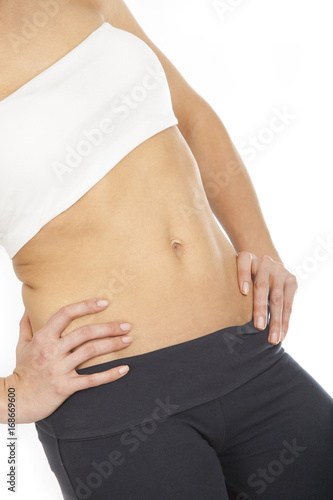 Slim woman showing her abdomen © Abdone