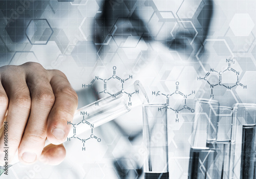 Tableau sur toile Portrait of concentrated male scientist working with reagents in laboratory