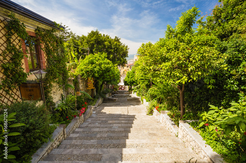 Romantic street of Corso Umberto in beautiful town of Taormina, Sicily island, Italy