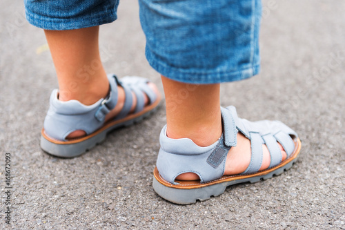 Close up image of new beautiful kids shoes on child s feet