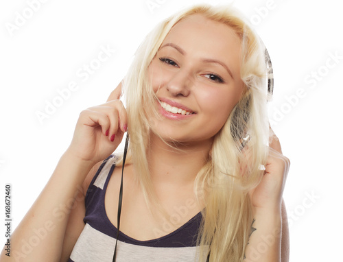 Young woman listening to music. Happy and headphones.