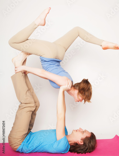 lifestyle, sport and people concept: Young couple in yoga pose