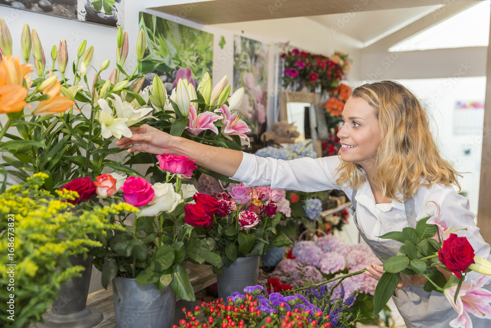 Gorgeous florist picking flowers to make a bouquet