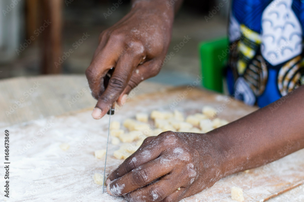Female hand cutting a flour paste