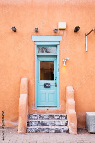 Teal door on an adobe house in Santa Fe, New Mexico