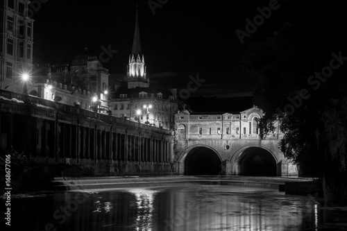 Pulteney Bridge and weir at night black and white. Palladian bridge in Bath, Somerset, UK, with River Avon flowing underneath at night