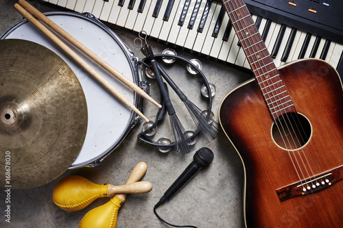 Fototapeta a group of musical instruments including a guitar, drum, keyboard, tambourine