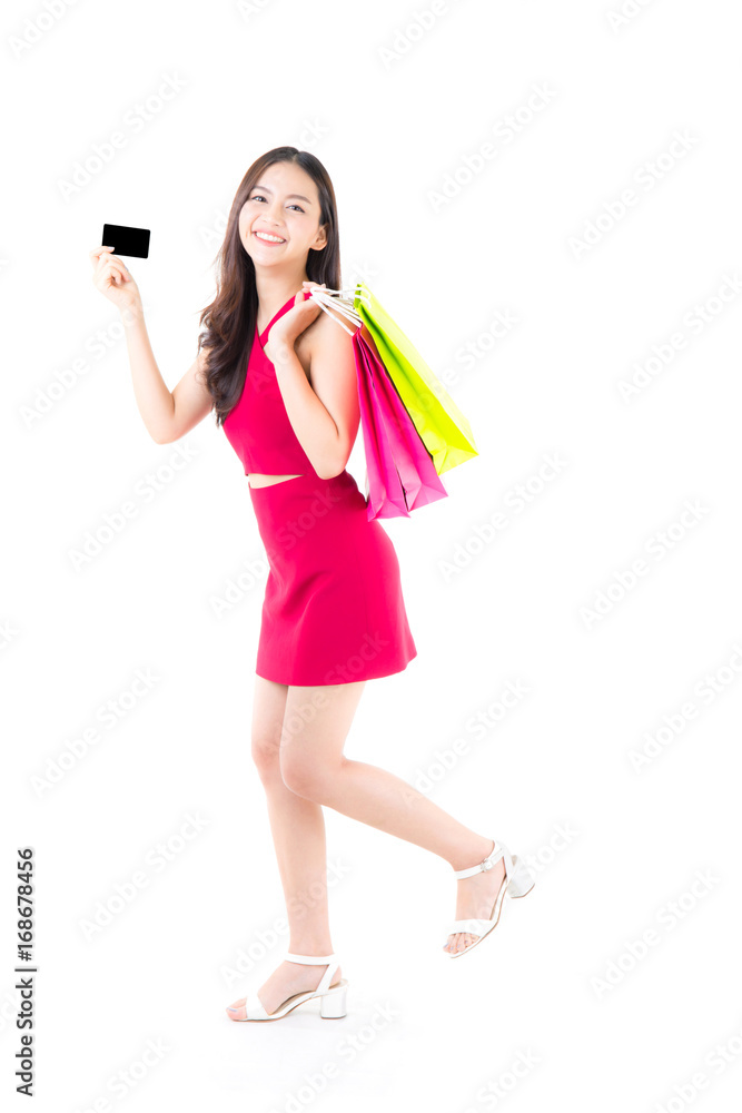 Asian young woman with red dress holding a credit card and bag paper colorful isolated on white background. Asian young woman with red dress holding a credit card and bag paper colorful isolated on white background.