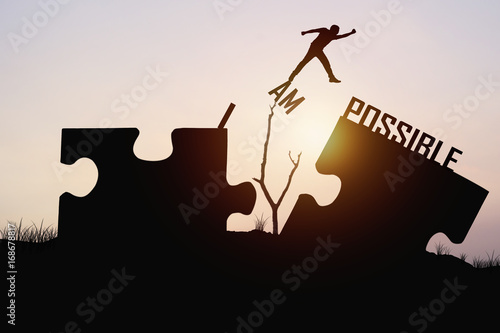 man jumping over jigsaw opposite possible shore, concept asbelieve and faith to conncet business photo