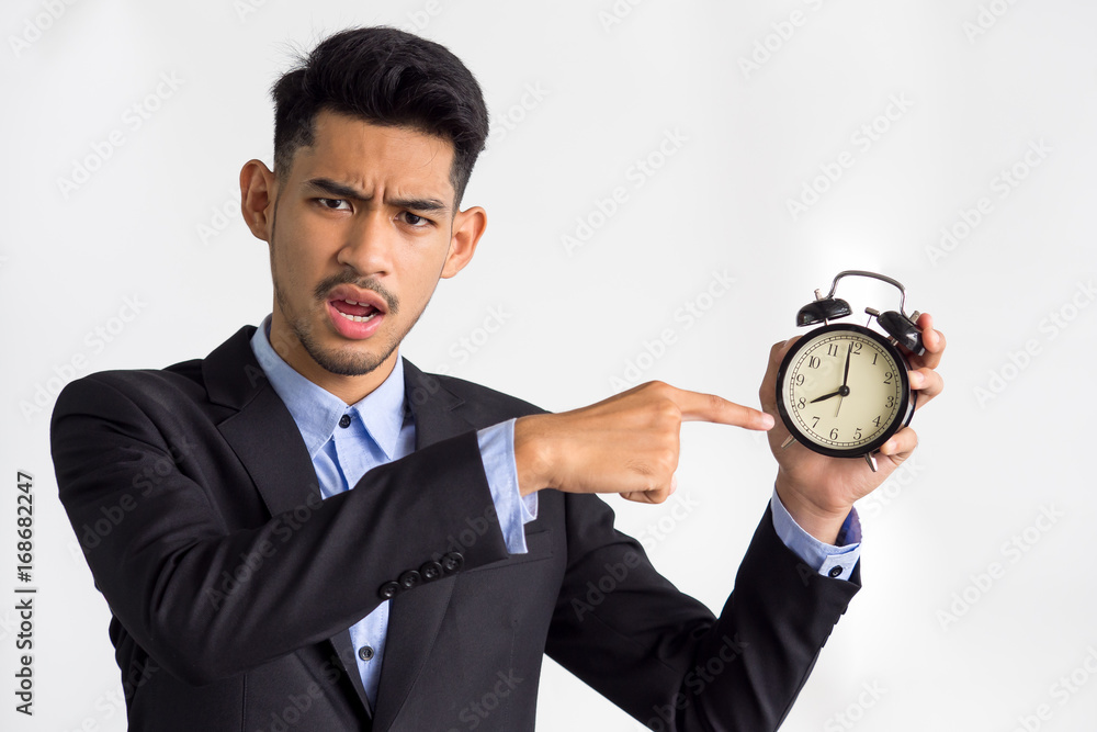 Businessman/boss/manager showing alarm clock on white background, working time, late, punctual concept. Businessman/boss/manager showing alarm clock on white background, working time, late, punctual concept.