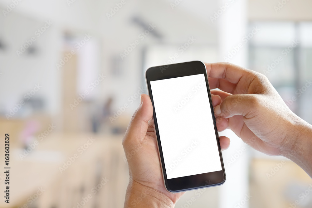 Man hands holding blank screen a smartphone and blurred background. Man hands holding blank screen a smartphone and blurred background.