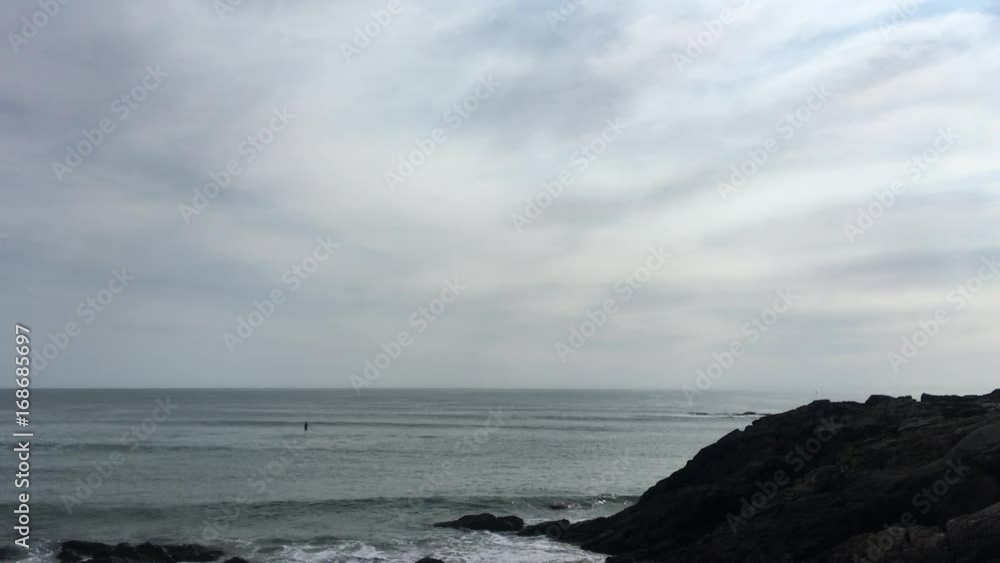 morning ocean waves with distant paddleboarder in Ogunquit, Maine morning ocean waves with distant paddleboarder in Ogunquit, Maine