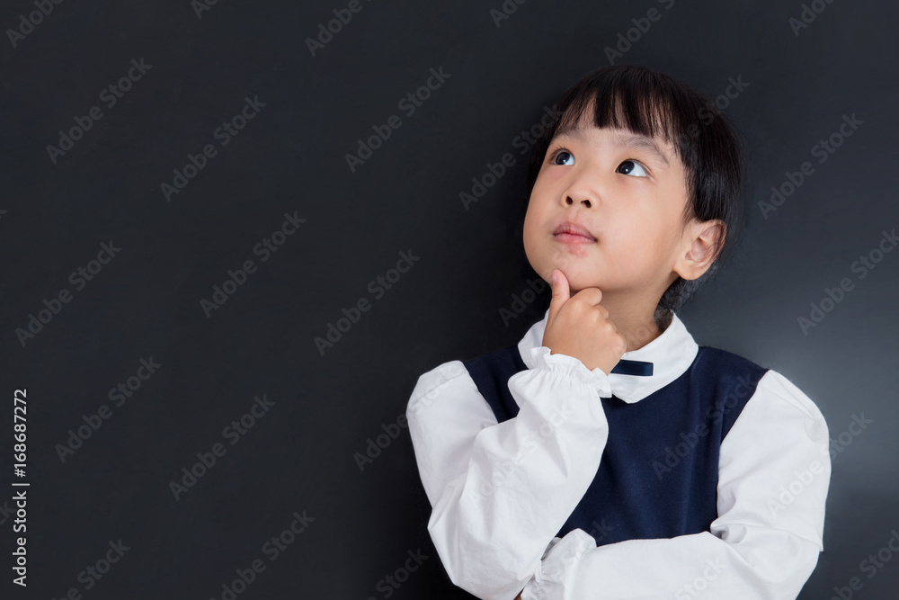 Asian Chinese little girl standing in front of blackboard Asian Chinese little girl standing in front of blackboard