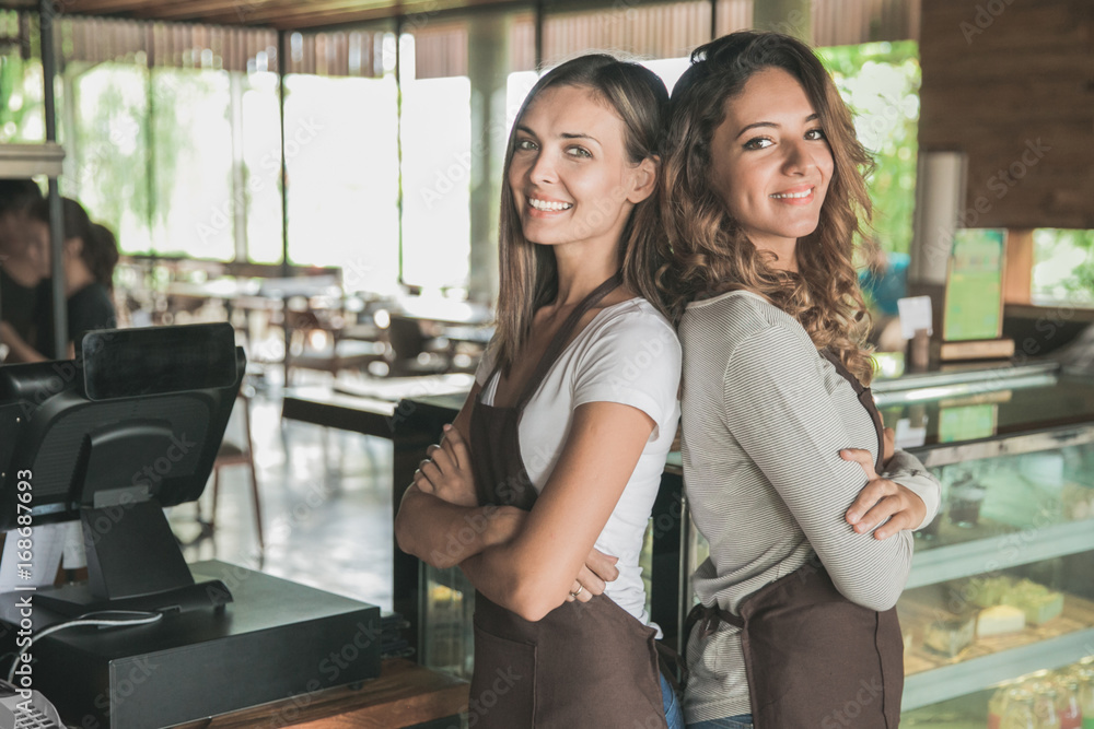 © Odua Images - two beautiful female waitress smiling to camera