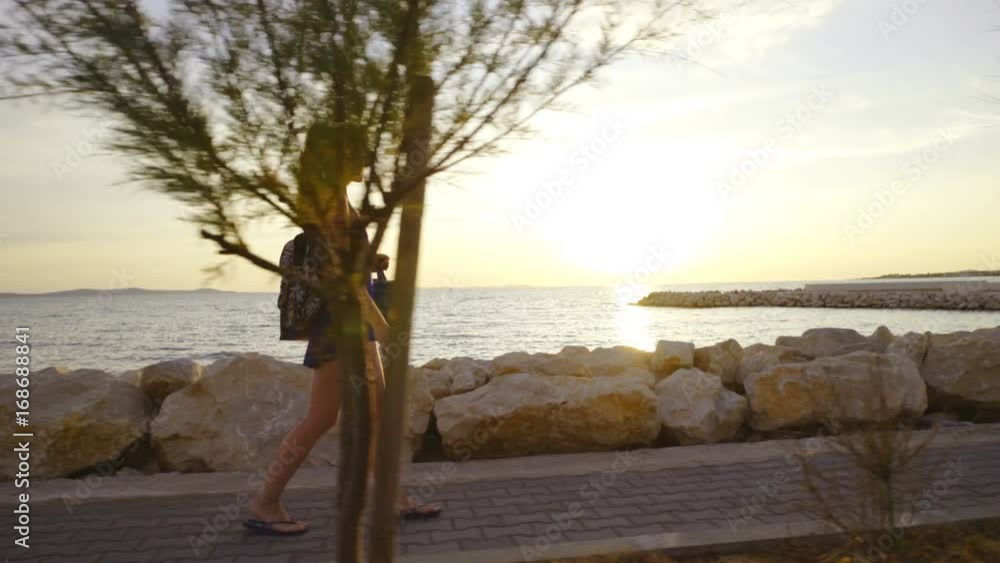 Woman walking at sunset on beach 4K Woman walking at sunset on beach 4K