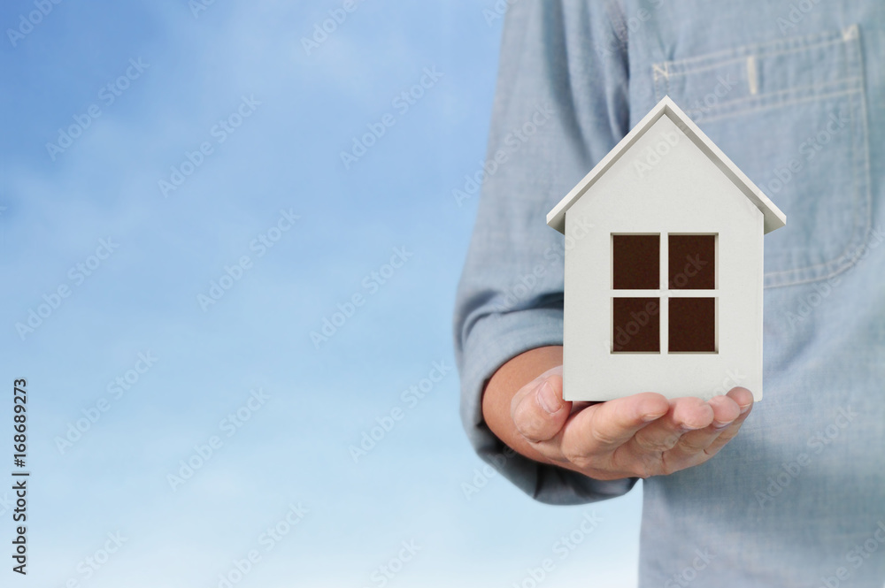 Mortgage concept by house from hand Mortgage concept by house from hand