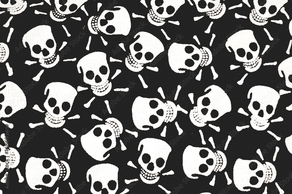 Color print on cotton fabric. White skulls and bones on a black background Color print on cotton fabric. White skulls and bones on a black background