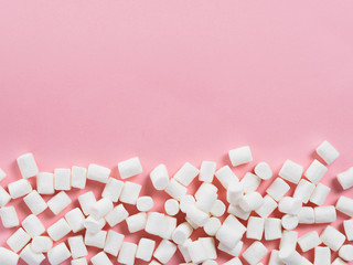 Marshmallows on pink background with copyspace