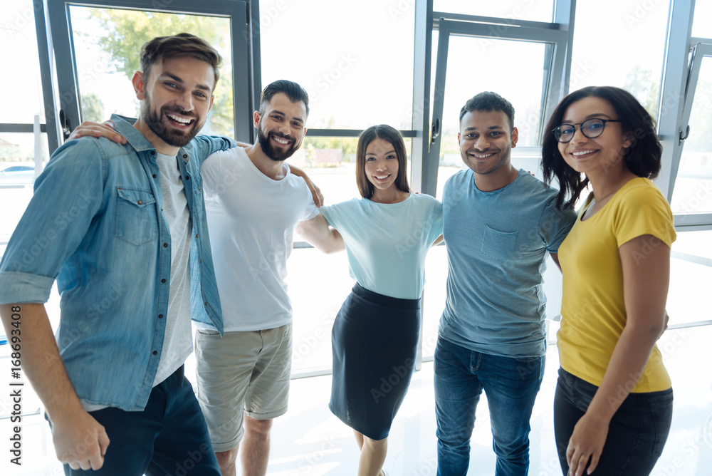 Fototapeta premium Happy young people looking at you