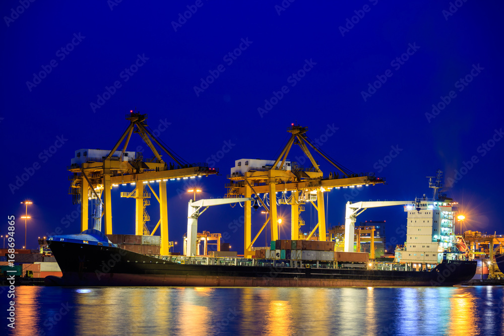 Shipping port. Logistics and transportation of international import export container cargo ship with crane bridge in harbor at twilight dusk for shipping and transportation industry