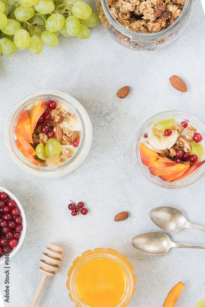 Healthy breakfast food table: granola, fruits, yogurt and honey. Table top view Healthy breakfast food table: granola, fruits, yogurt and honey. Table top view