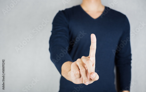 Man index finger gesture, wearing long-sleeved shirt, no face on grey background