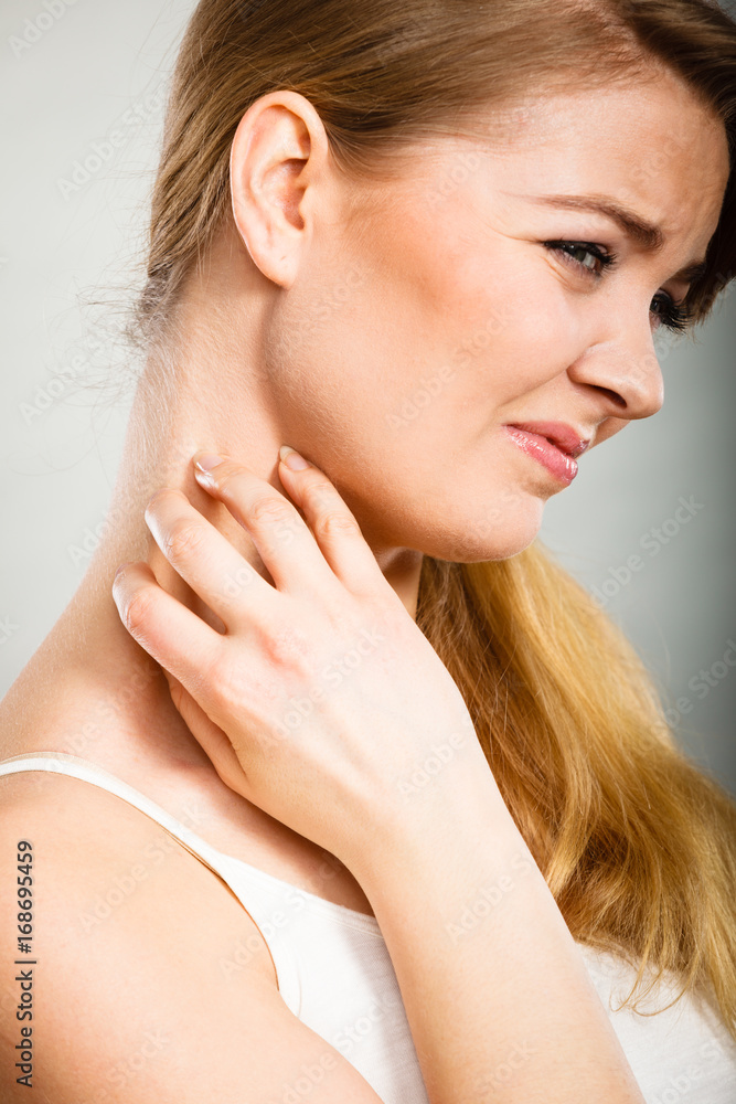 woman scratching her itchy neck with allergy rash woman scratching her itchy neck with allergy rash