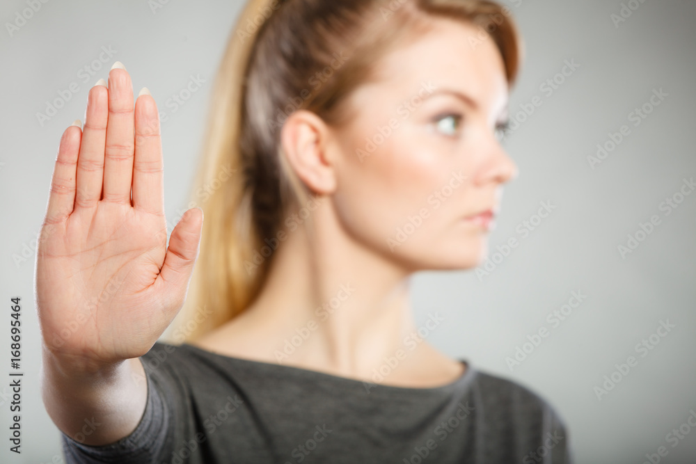Female shows stop sign by her hand. Female shows stop sign by her hand.