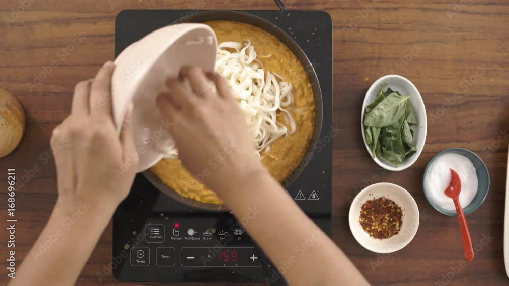 Cooking Fettuccine Pasta in Red Bell pepper Sauce Cooking Fettuccine Pasta in Red Bell pepper Sauce