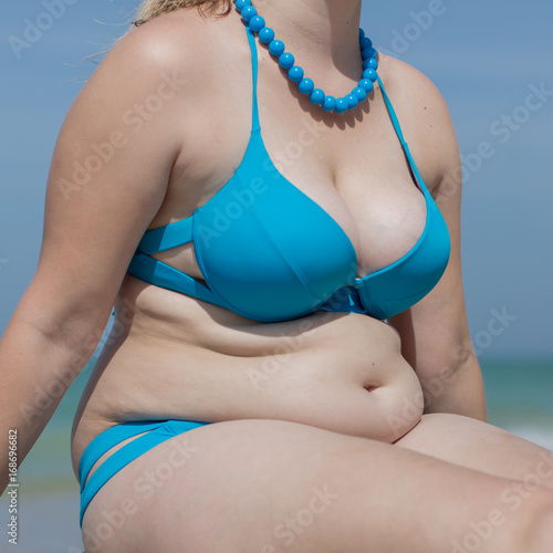 Obraz na plátně Torso of adult woman in swimsuit and beads, square composition