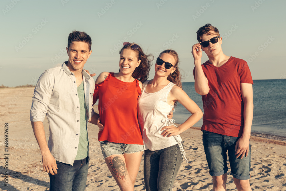 Group of young people enjoy summer party at the beach