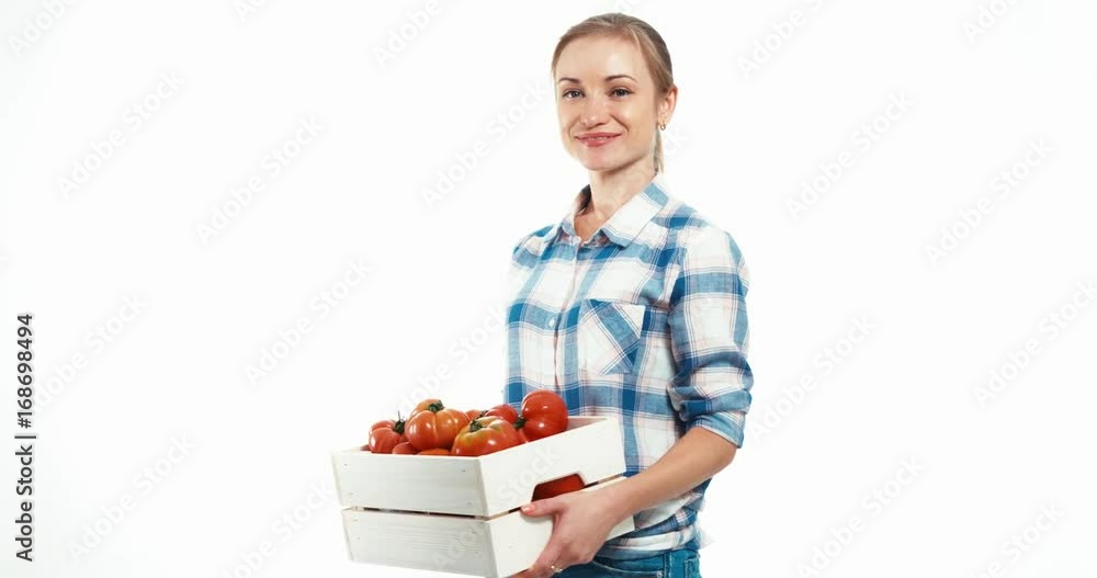 Portrait young woman holding box of tomato on white background Portrait young woman holding box of tomato on white background
