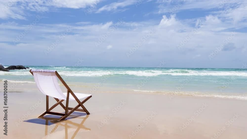 White chair on Katanoi beach, Phuket, Thailand on a beautiful sky. White chair on Katanoi beach, Phuket, Thailand on a beautiful sky.