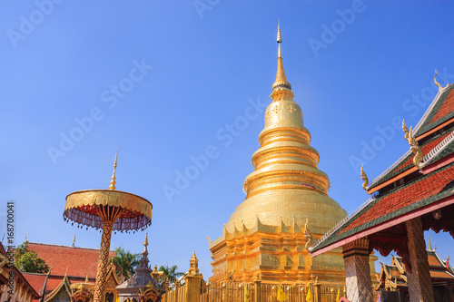 Ancient Pagoda Statue / Ancient Pagoda Statue Of Wat Phra That Hariphunchai With Blue Sky Background. © anonymous6059