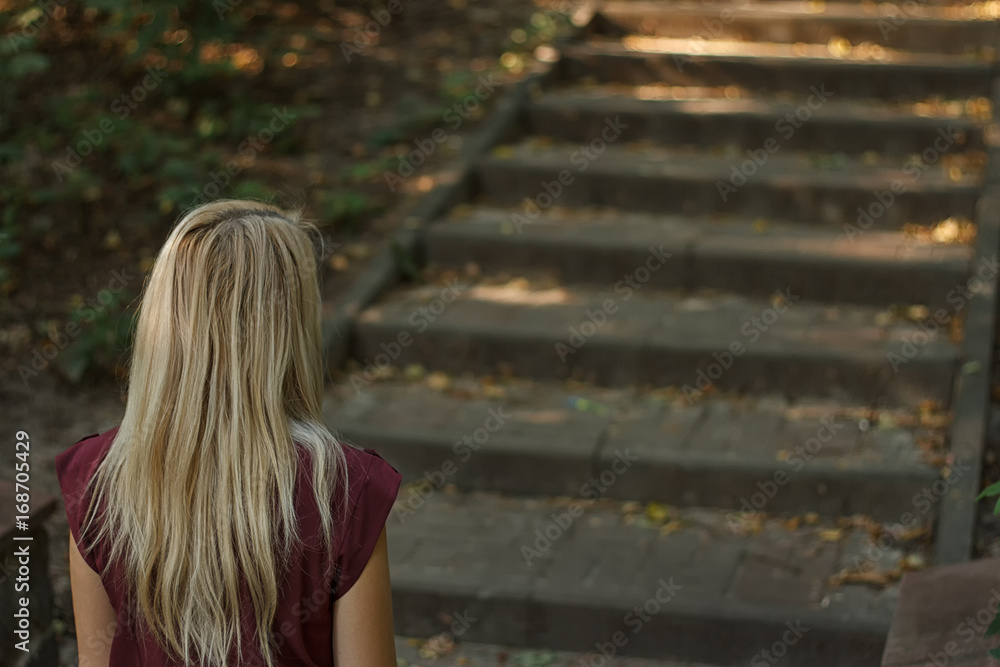 woman going up the stairs in the park