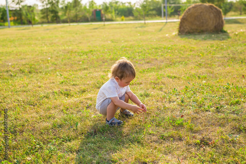 Summer, childhood and baby concept - little boy having fun in summer nature