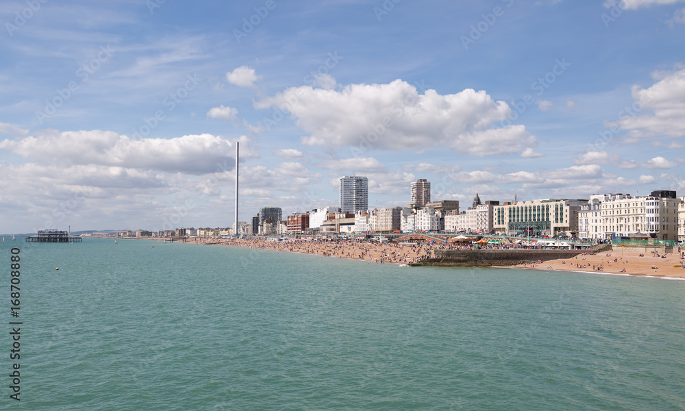 Naklejka premium Brighton seafront and town with people enjoying the sunny beach