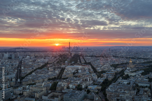 Scenic aerial view of Paris, France, from the Tour Montparnasse with the Eiffel Tower in the background. Colourful nighttime skyline. Travel background. © Funny Studio